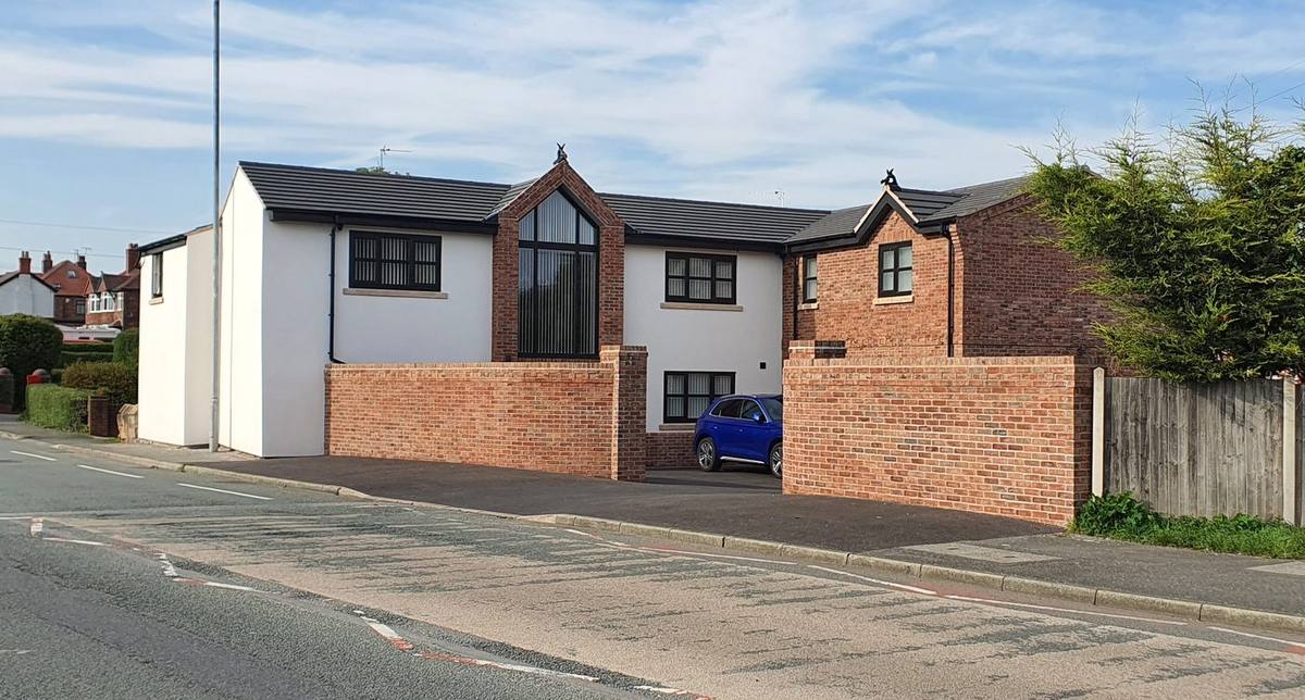 Cottage after full remodel with brick and render, glazed gable