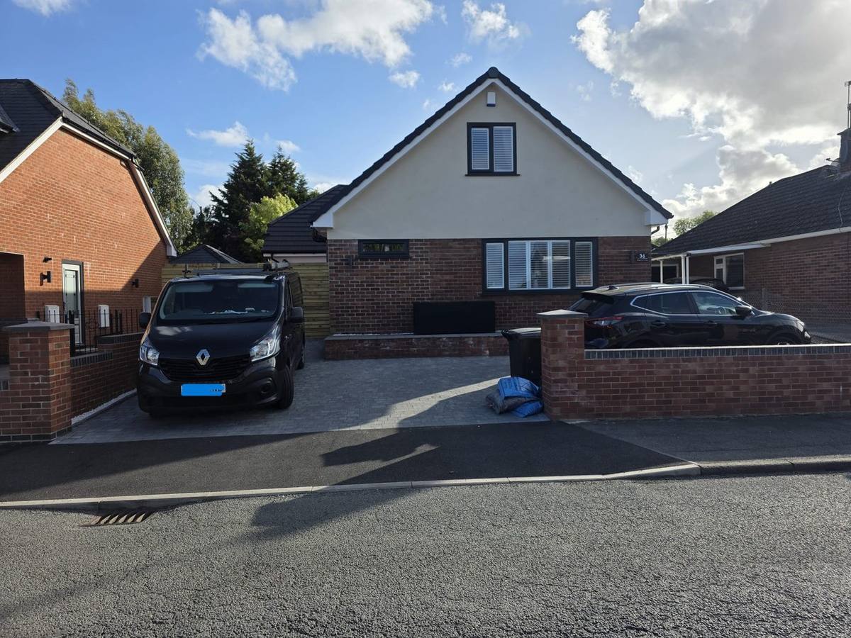 Bungalow after dormer conversion with render gable and new driveway, Hawarden